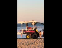 Guy ignores beach rangers battle with waves