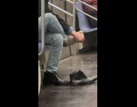 Guy picks foot while riding the subway