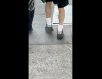 Man on Oversized Shoes with Accessories Walks Dog