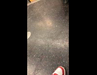 Shirtless man in black shorts sitting along on train