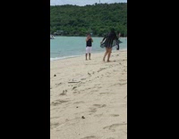 Girl enjoys filming content at the beach