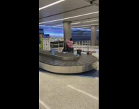 Two woman twerk moan baggage conveyor airport