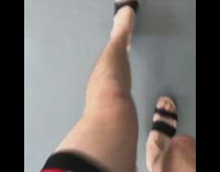 Guy in black heels red dress walks to tall mirror and screams into phone