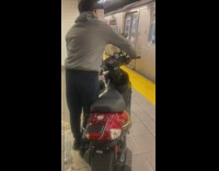 Guy take his motorcycle inside subway train 