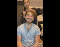 Girlfriend straightens boyfriend hair flat iron