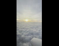 View above the clouds and the sun inside the airplane