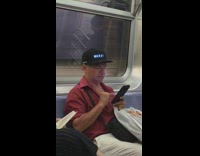 Man wears marquee that that says God does not exist on subway train