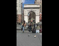 Guy sitting on park water fountain sings 