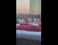 Four people in two different photoshoot on the rooftop restaurant