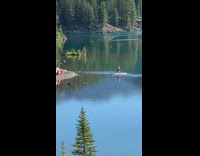 Woman bikini kneel yoga exercise board lake