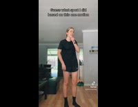 Collab BitchIG2 - Girl in black shirt and shorts puts hands up steps back