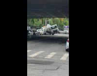 White van car found stuck against appliance 