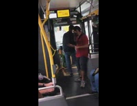 Two old men argue front of bus