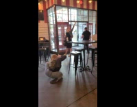 Woman raises her hand beside the restaurant exit