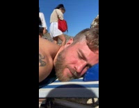 Two women selfie behind man at beach