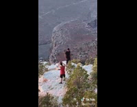 Two men photo shoot top of mountain