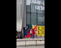Three people dances outside The Bloomberg building