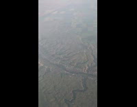 Airplane ride view over badlands mountains cracks