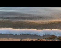 Ocean waves make small ice wall shore
