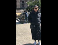 Brunette girl runs college campus checks phone