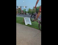 Pink shorts guy bicycle white sign fail 