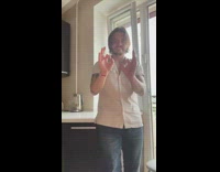 Collab PLC - Guy records himself dancing with pug inside of kitchen to music 