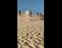 Collab IITW - Woman bikini throws beach sand in air