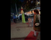 The Grinch wears stilts walks on street