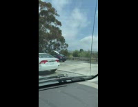 Surfboard tied to car sticks up