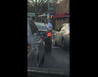Car driver punches car next to him 