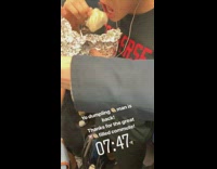 Guy eats dumpling out of aluminum foil wrap on the subway