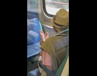Guy in pink lays bare feet on train seat 