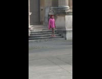 Woman pink coat bag walk down stairs