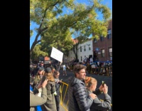 Woman holds board about date on marathon