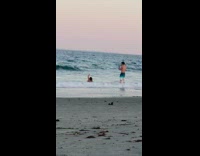 Woman bikini crawls beach waves outbalanced pictorial