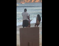 Two women bikini bend and flex their butt at the beach