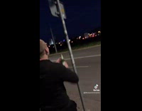 Guy open beer bottle with street sign