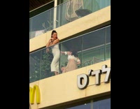 Model Poses on Balcony During Golden Hour