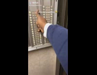 Guy presses all buttons on door apartment