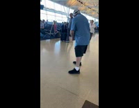 Man blue shirt play VR golf  airport