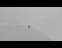 Three person hiking walks on icy mountain