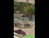 Man in yellow briefs bends body on the pool