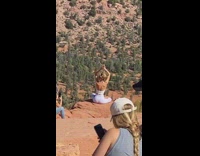 Woman white outfit hands in air canyon pictorial