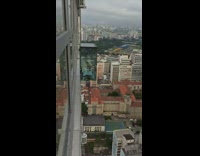 Woman lie down on the glass on the building