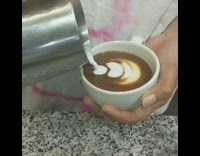 Girl makes coffee latte art white mug