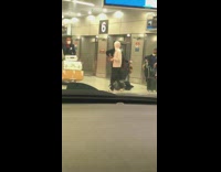 Woman grey sweater remove face mask airport