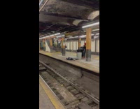 Lady carries trash can onto train 