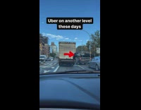 Guy sits on back of moving truck 