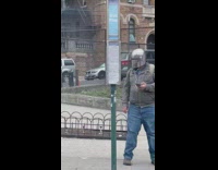 Man Wears Sci-Fi Helmet on Sidewalk as Mask 