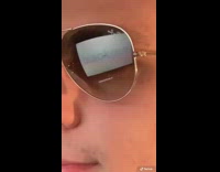 Guy types screen reflects on aviator sunglasses 